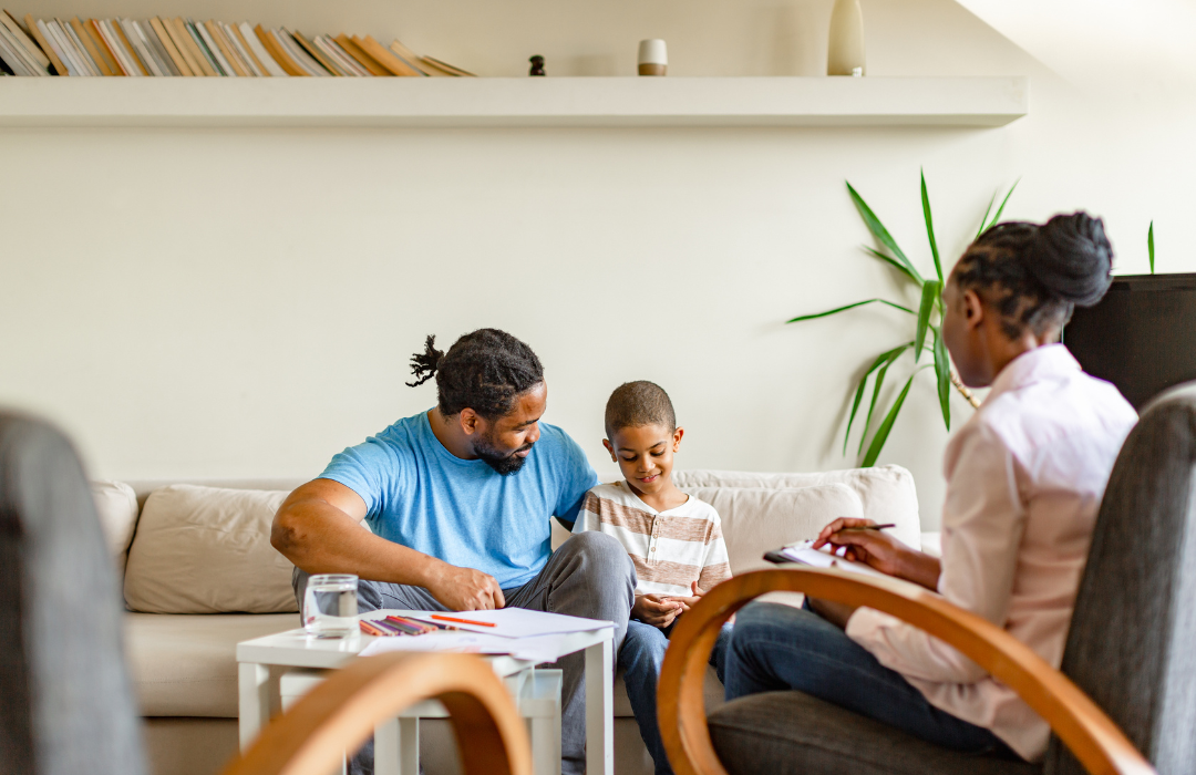 Photo of a therapist with father and son